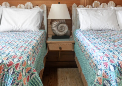 Room 7 - 2 double beds with blue bedspreads with colorful fish