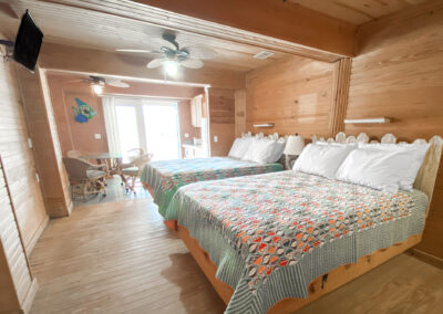 Room 7 - 2 double beds with blue bedspreads with colorful fish