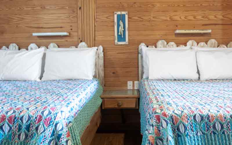 Room 6 - 2 double beds with blue bedspreads with colorful fish