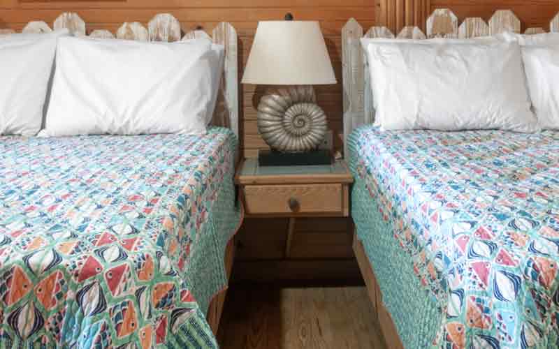 Room 7 - 2 double beds with blue bedspreads with colorful fish