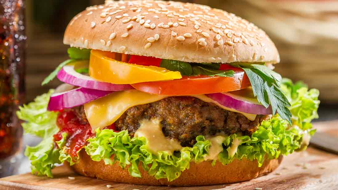 Burger Port Aransas - Hamburger with lettuce, tomatoes and red onions.