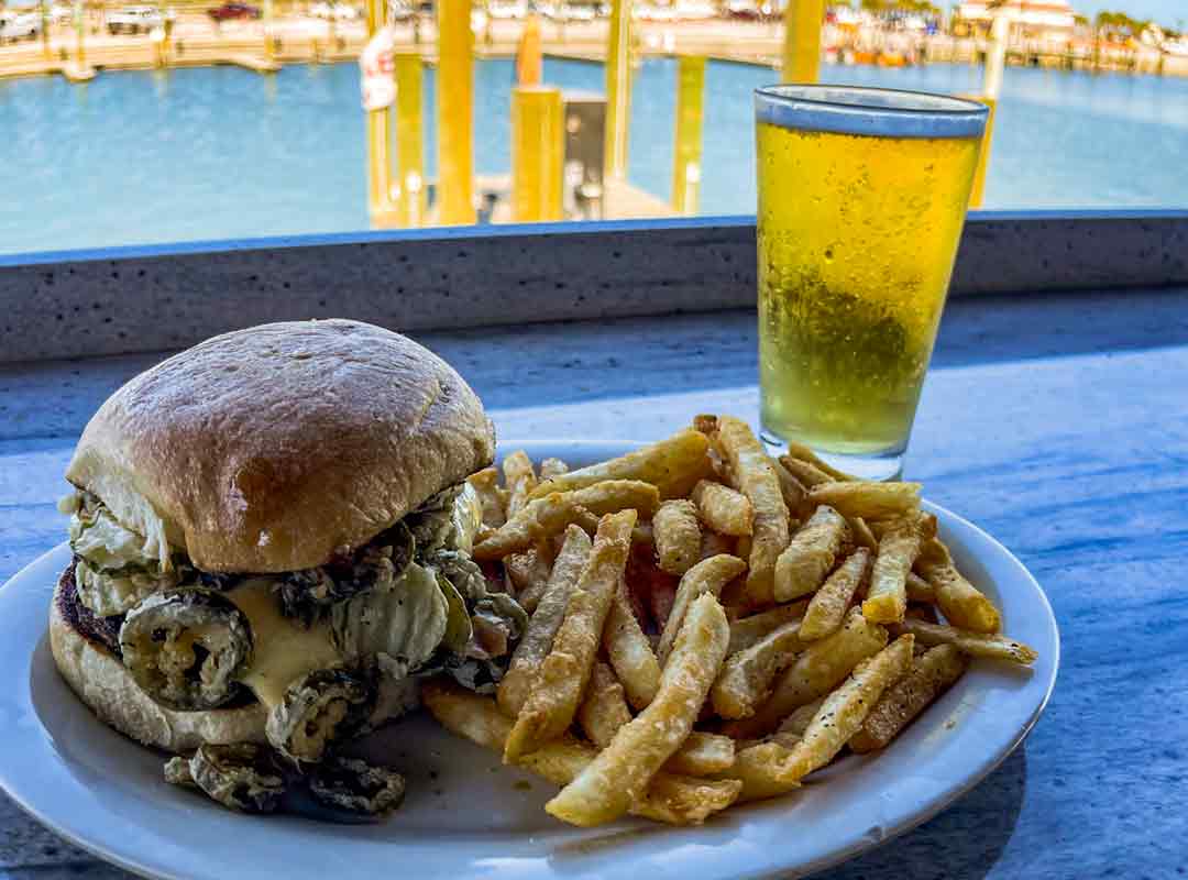 Port “A” Burger - Thick white queso, fried pickles and jalapeños with chipotle mayo served on a sour dough bun