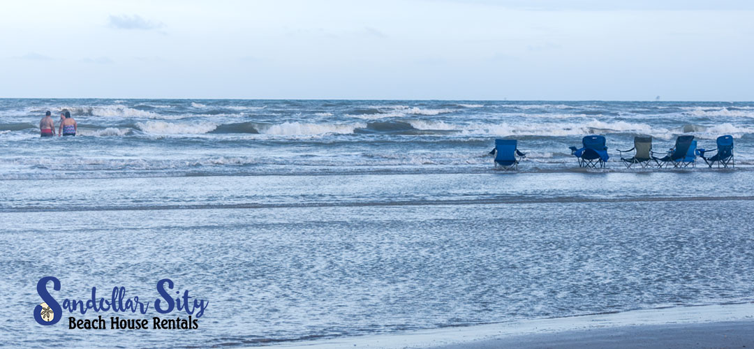 Blue beach chairs in the water