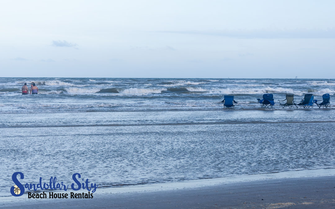 Blue beach chairs in the water