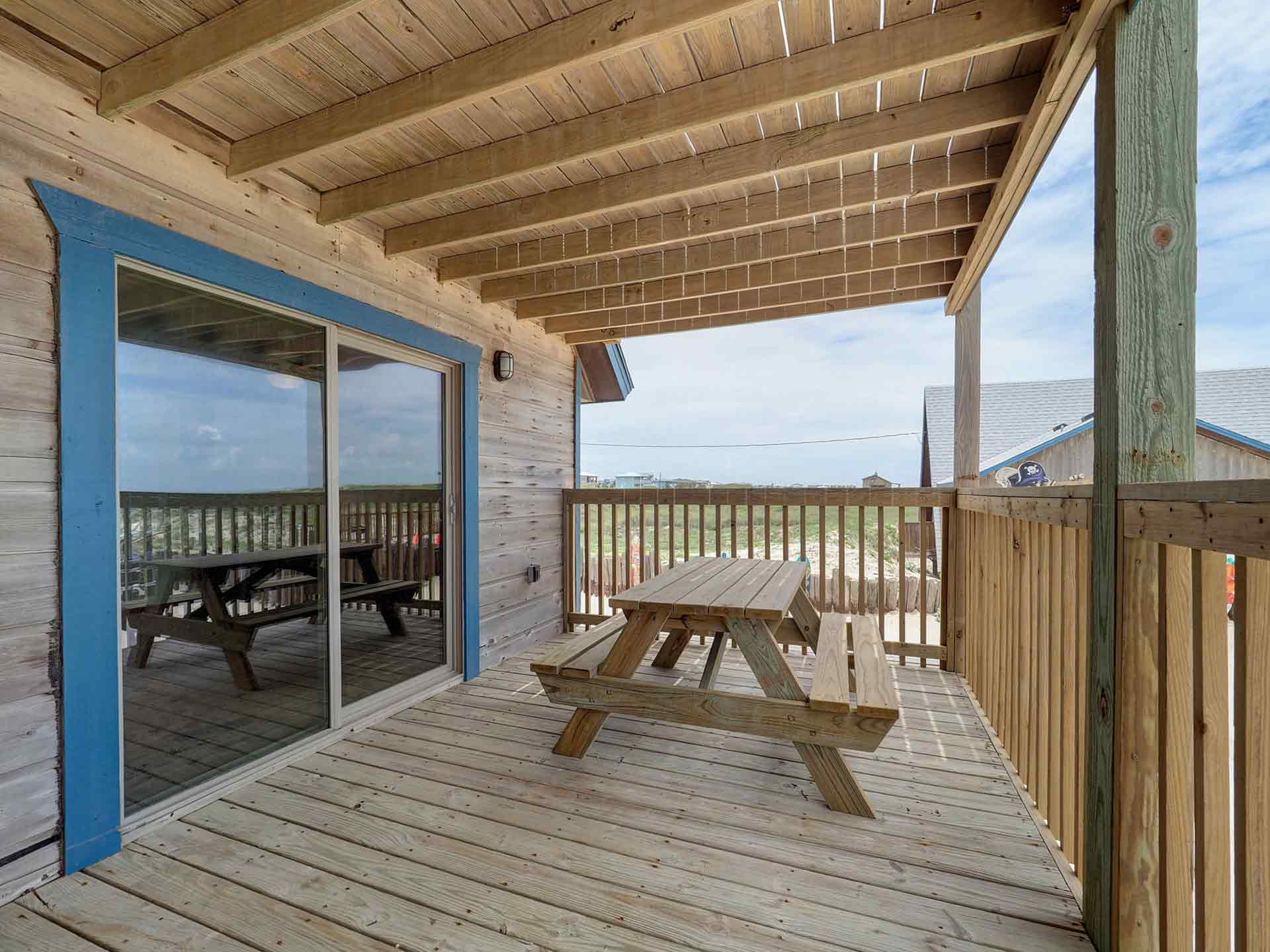Wooden patio with blue framed sliding doors
