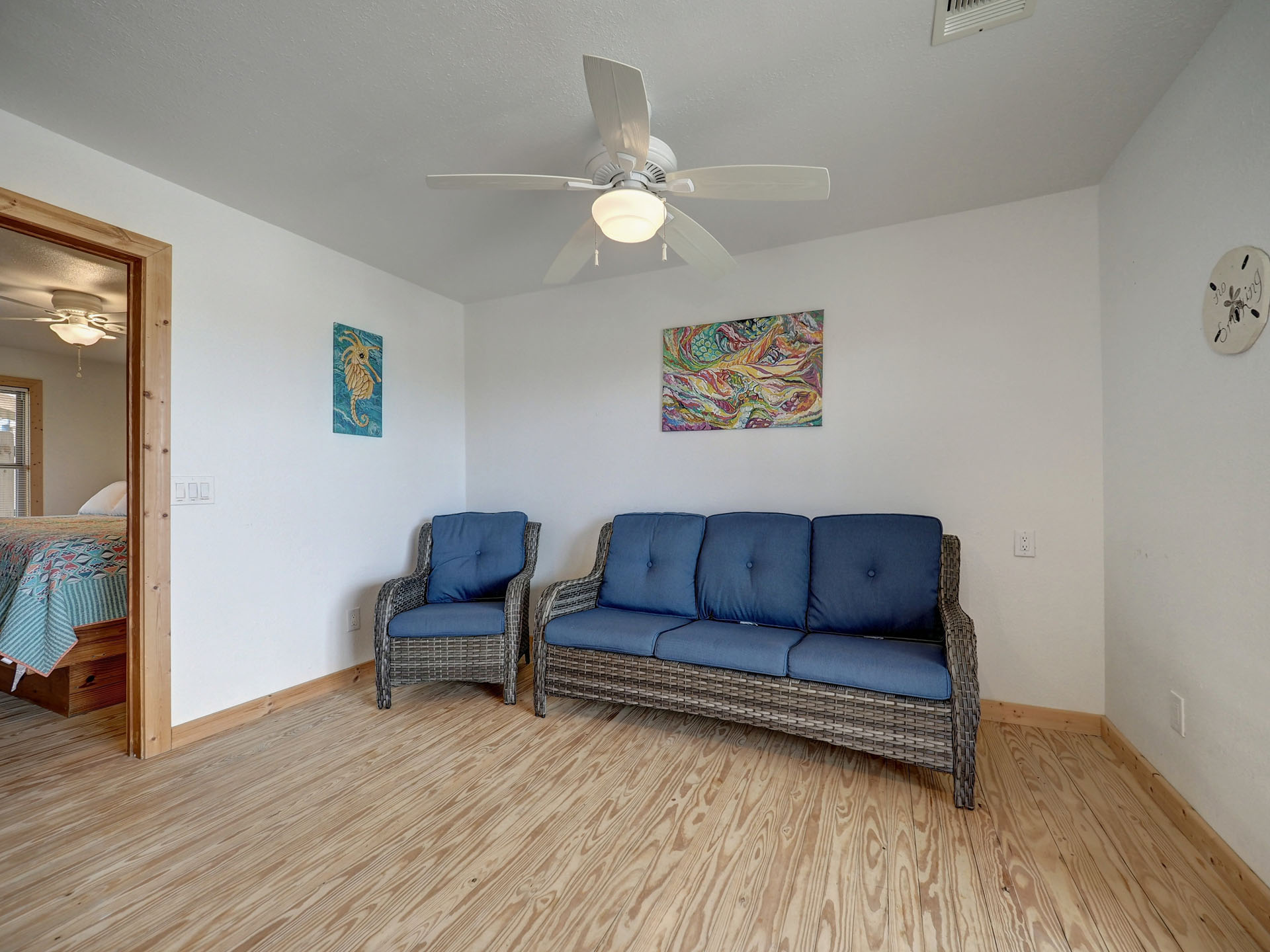Seating area with blue rattan sofa and chair