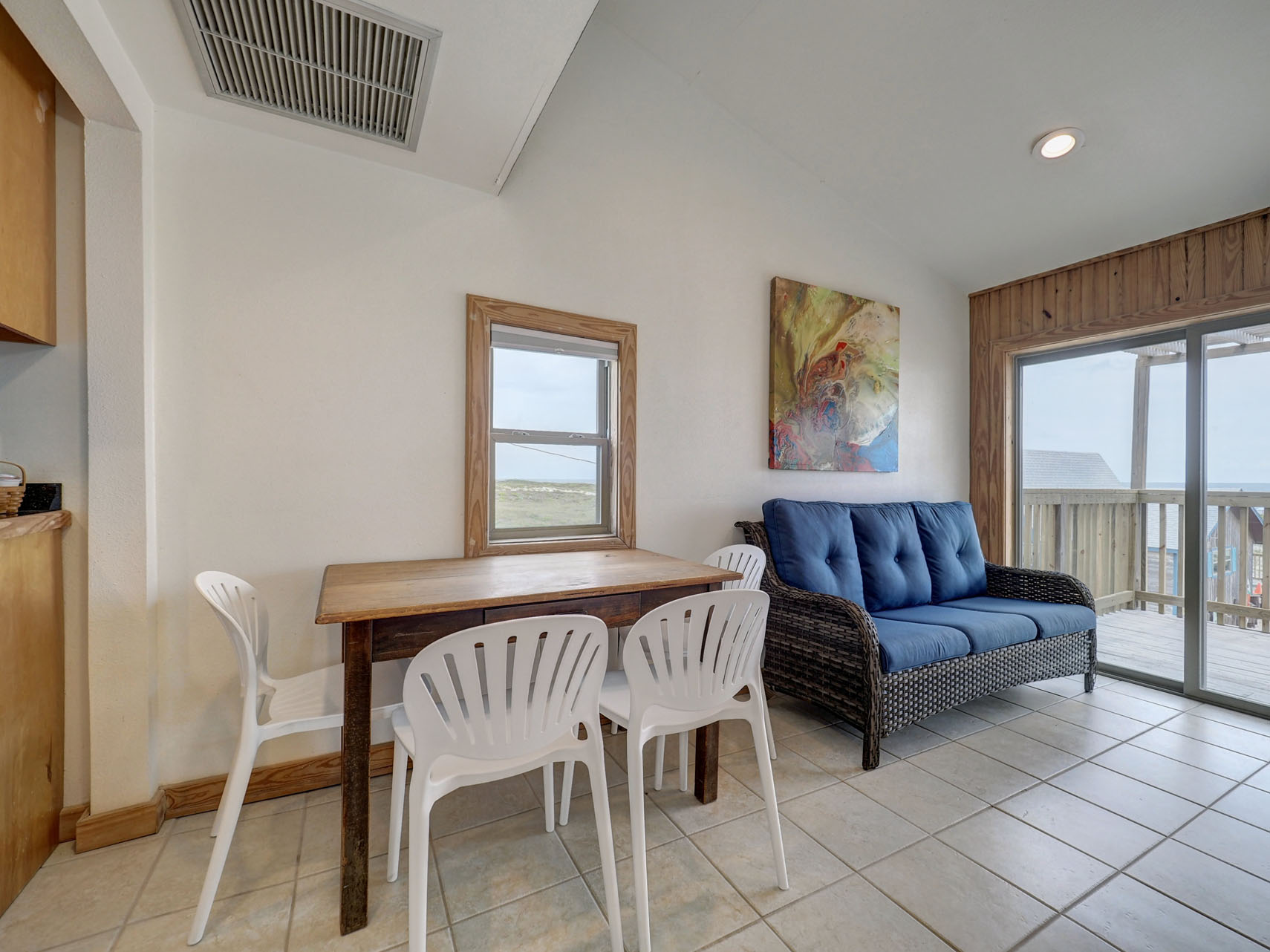 Table with 4 chairs and rattan sofa